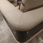 Cream Leather Sofa with Dark High-Gloss Wood Panels, Monogram Cushions and Metal Base Trim